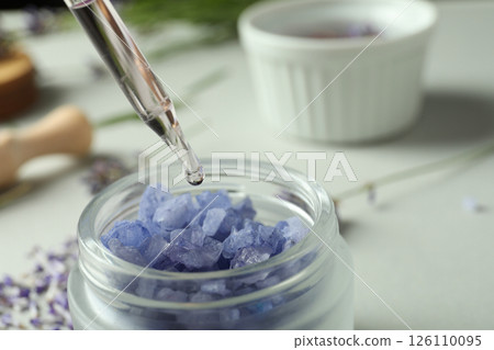 A dropper with lavender oil and a lavender flower close-up 126110095