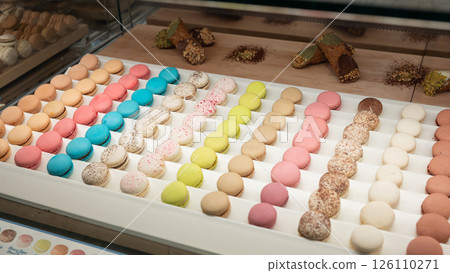 National Macaron Day. Colorful macarons displayed in a pastry shop National Macaron Day. Colorful macarons displayed in a pastry shop 126110271