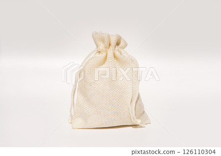 Beige burlap drawstring bag on white background 126110304