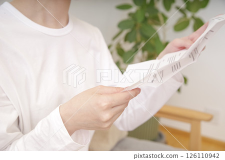 Asian woman looking at documents 126110942