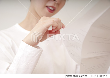 Asian woman looking at documents Asian woman looking at documents 126110944