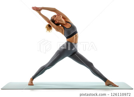 Woman practicing yoga in a serene studio space during a morning routine focusing on flexibility and strength Woman practicing yoga in a serene studio space during a morning routine focusing on flexibility and strength 126110972