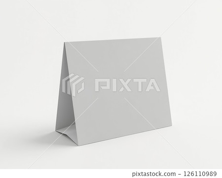 Simple gray tent card stands on a clean surface, ideal for displaying information or decor in various settings Simple gray tent card stands on a clean surface, ideal for displaying information or decor in various settings 126110989
