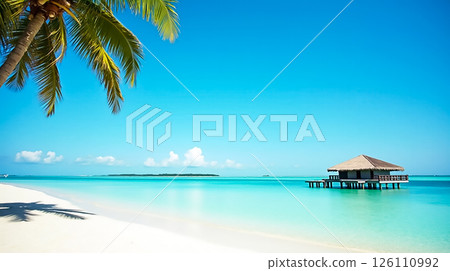 Tropical beach with clear waters and a wooden hut under a bright blue sky during midday light 126110992
