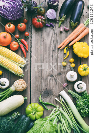 White, yellow, green, orange, red, purple fruits and vegetables on wooden background.  Healthy food. Multicolored raw food. Copy space 126111248