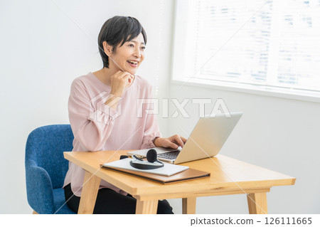 A woman using a computer A woman using a computer 126111665