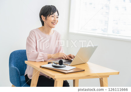 A woman using a computer A woman using a computer 126111666