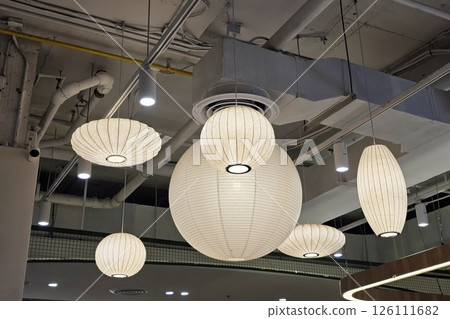 White Origami Paper Lamps Hanging on the Ceiling. 126111682