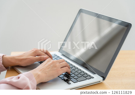 A woman's hand using a personal computer 126111829