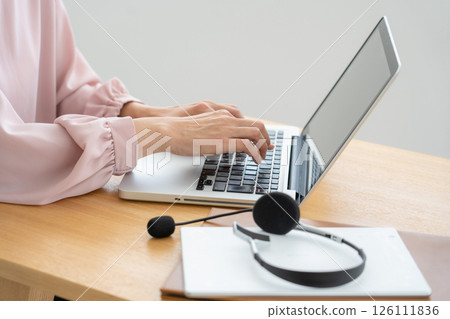 A woman's hand using a personal computer 126111836