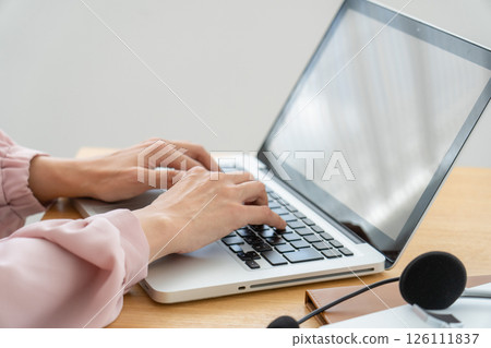 A woman's hand using a personal computer 126111837