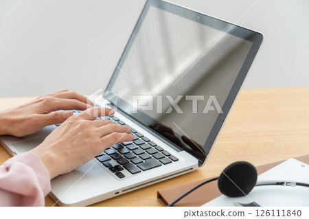 A woman's hand using a personal computer 126111840