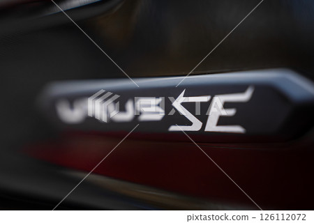 Close up view of the Urus S badge on a Lamborghini Urus, displayed on a sleek, dark surface with a blurred background emphasizing the badge. 126112072