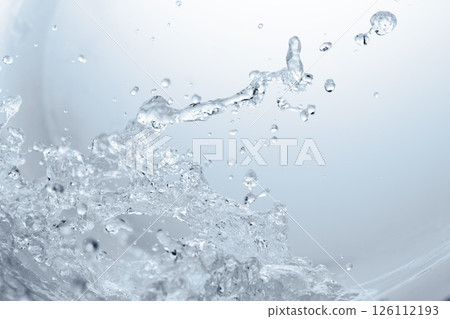 Violent splashes of water on a blue background. 126112193