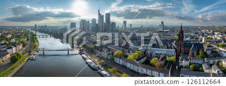 Aerial image of Frankfurt, Germany, featuring modern skyscrapers, the River Main, Eiserner Steg bridge, and the historic Frankfurt Cathedral. Aerial image of Frankfurt, Germany, featuring modern skyscrapers, the River Main, Eiserner Steg bridge, and the historic Frankfurt Cathedral. 126112664