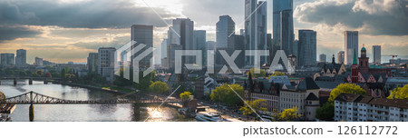Aerial view of Frankfurt, Germany, featuring modern skyscrapers like Commerzbank Tower, the River Main, Eiserner Steg, and historic European architecture. 126112772