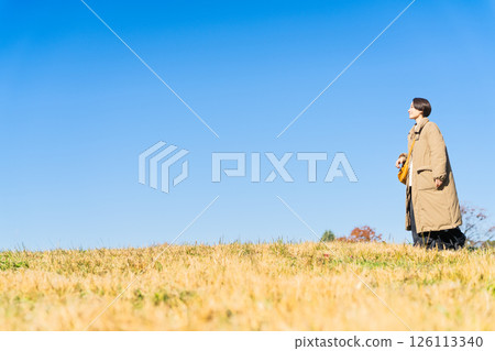 Woman walking up the hill lifestyle image Woman walking up the hill lifestyle image 126113340