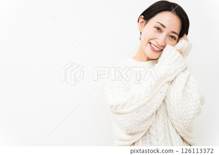 Woman wearing white knitwear Lifestyle image Woman wearing white knitwear Lifestyle image 126113372