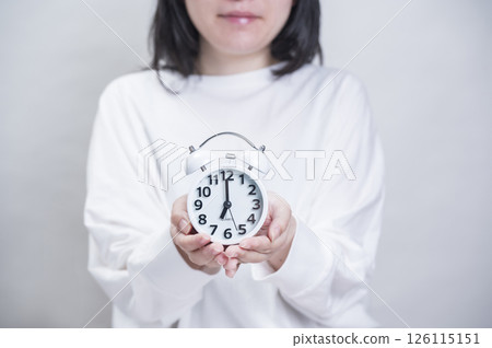 A woman with an alarm clock A woman with an alarm clock 126115151