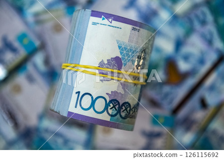 Thick wad of money cash on table 126115692