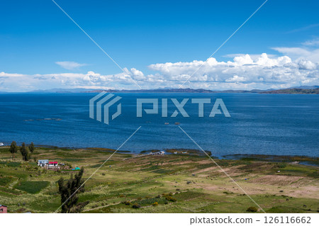 Lush green landscape overlooking Lake Titicaca from Llachon, Peru 126116662