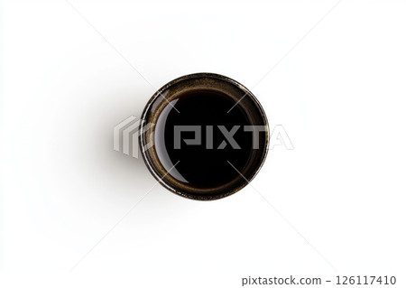 Photograph of a cup with black coffee, viewed from above, isolated on a white background. 126117410