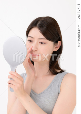 A woman troubled watching a mirror 126117601