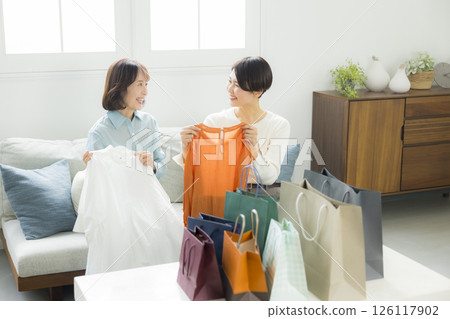 A woman returning home from shopping 126117902