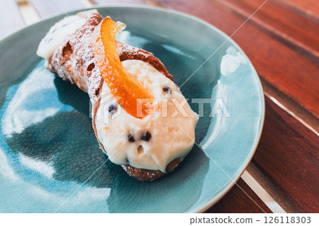 Cannoli on a plate, a sweet treat ready to be enjoyed.. 126118303