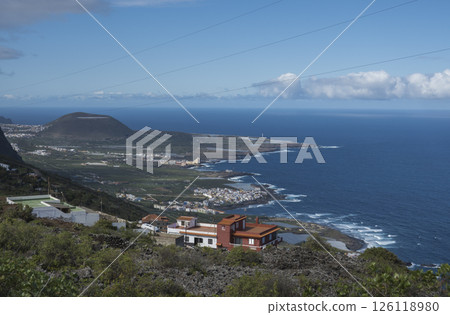 Aerial view of colorful houses near old town Garachico from Mirador de Garachico view point.. Green cean shore with lava rocks. Popular tourist destination, Tenerife Canary Islands. 126118980