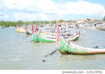 Serene Beach Scene A Boat Resting on the Shore 126119762