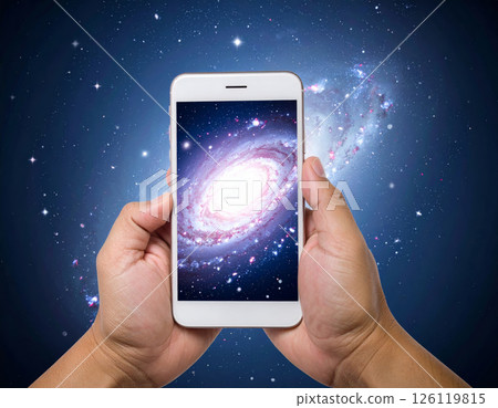 person holds smartphone displaying vibrant galaxy, symbolizing connection between technology and universe. cosmic background enhances sense of wonder and exploration person holds smartphone displaying vibrant galaxy, symbolizing connection between technology and universe. cosmic background enhances sense of wonder and exploration 126119815