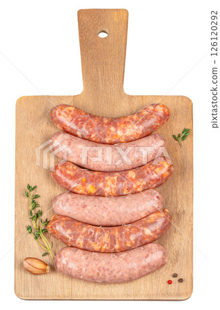 raw sausages with spices on cutting board isolated on white background. Natural healthy food concept. top view raw sausages with spices on cutting board isolated on white background. Natural healthy food concept. top view 126120292