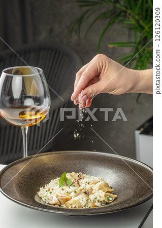 risotto with brown champignon mushrooms and white wine. dish of Italian cuisine risotto with brown champignon mushrooms and white wine. dish of Italian cuisine 126120309