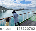 Back view of sisters gazing at the blue sea from the deck of a ship 126120702