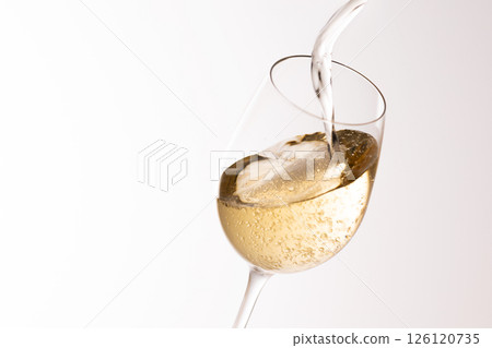 Pour white wine into the glass Pour white wine into the glass 126120735