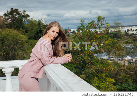 woman in pink dress drinking coffee cocktail with straw woman in pink dress drinking coffee cocktail with straw 126121745