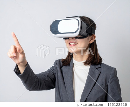 Businesswoman wearing VR goggles 126122216