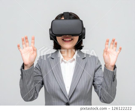 Businesswoman wearing VR goggles 126122222