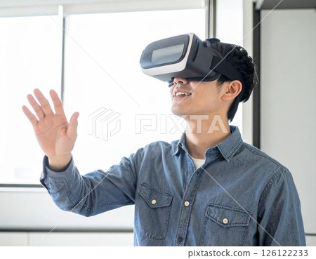 Businessman wearing VR goggles 126122233