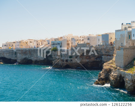 Polignano a Mare, Italy. View of the village. Old buildings on a cliff by the sea. 126122256
