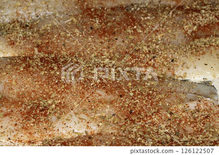 Close up of seasoned and herb fish waiting to be cooked 126122507