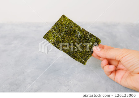 Homemade nori chip on neutral light background Homemade nori chip on neutral light background 126123006