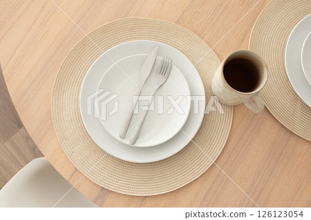 Minimalist table setting with coffee mug, top view 126123054