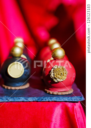 cake, sweets in the shape of perfume bottles and candles 126123183