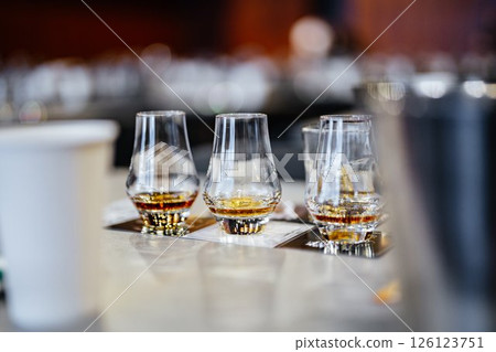 Tasting fine spirits at a cozy bar during an evening gathering 126123751