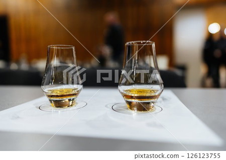Whiskey tasting session featuring two elegant glasses in a cozy setting 126123755