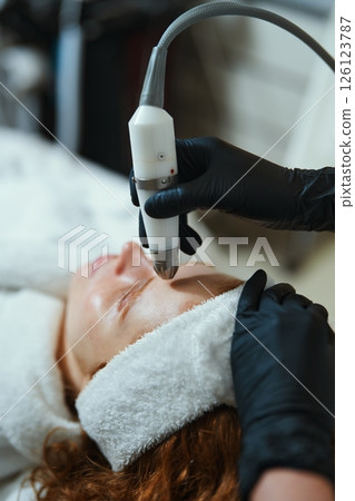 Skincare treatment in a clinic using a facial device for rejuvenation Skincare treatment in a clinic using a facial device for rejuvenation 126123787