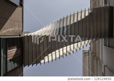 Looking up of The futuristic modern of Twisted sky bridge connecting Royal opera house to Royal ballet school in Covent garden. 126124650