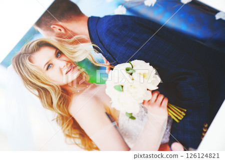 the pages of a photo book with wedding photos.  126124821